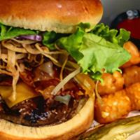 Texas Burger · Topped with Cheddar, Monterey Jack cheese, crispy bacon, onion straws and BBQ sauce on the s...