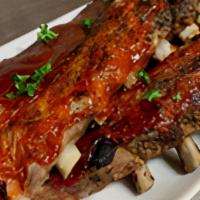 Bbq Babyback Ribs Half · The tenderest baby ribs, hickory smoked and covered with RJ's own BBQ sauce.