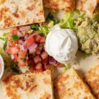 Quesadillas · Flour tortilla, cheddar, and jack blended cheese  served with shredded lettuce, sour cream, ...