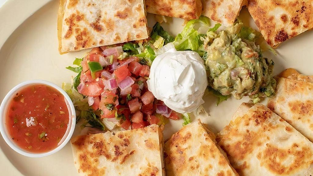 Quesadillas · Flour tortilla, cheddar, and jack blended cheese  served with shredded lettuce, sour cream, pico de gallo, and fresh guacamole