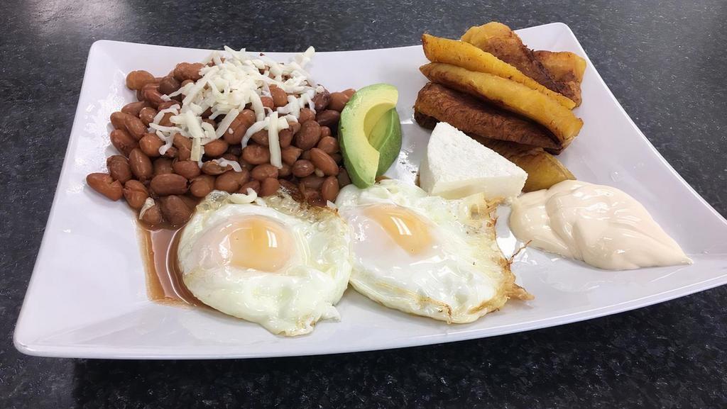 Desayuno Típico · Served with fried plantain, refried beans, sour cream, cheese, beans, Avocado and Chorizo