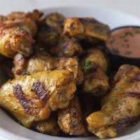 Chicken Wings · Char-grilled jumbo party wings in our dry rub house seasoning.