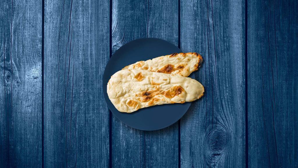 Naked Naan · A refined flour leavened flatbread, baked in a clay oven till crisp on the outside and soft on the inside.