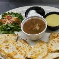 Quesadillas · Grilled flour tortilla filled with melted Monterey jack cheese, choice of chicken or beef.