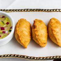 Yindee Curry Puffs · Minced chicken, potatoes and onions in yellow curry served with cucumber and onion relish.