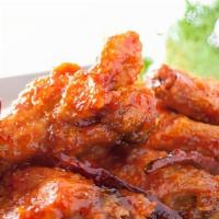 Sweet & Spicy Wings · Spicy. Crispy chicken wings with roasted Thai peppers tossed in sweet chili sauce.