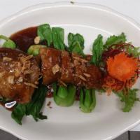 Tamarind · Crispy duck with tamarind sweet: sour sauce on top of fried shallots, served with mixed vege...