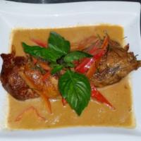 Panang Ped · Spicy. Crispy duck with panang curry coconut milk, red peppers, and lime leaves.