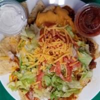 Taco Salad · Tortilla Chips topped with Seasoned Ground Beef, Chili, Nacho Cheese, Lettuce, Diced Tomato ...
