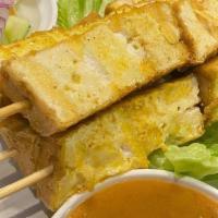 Tofu Satay · Skewers of Tofu, marinated in light curry served with peanut sauce and cucumber salad.