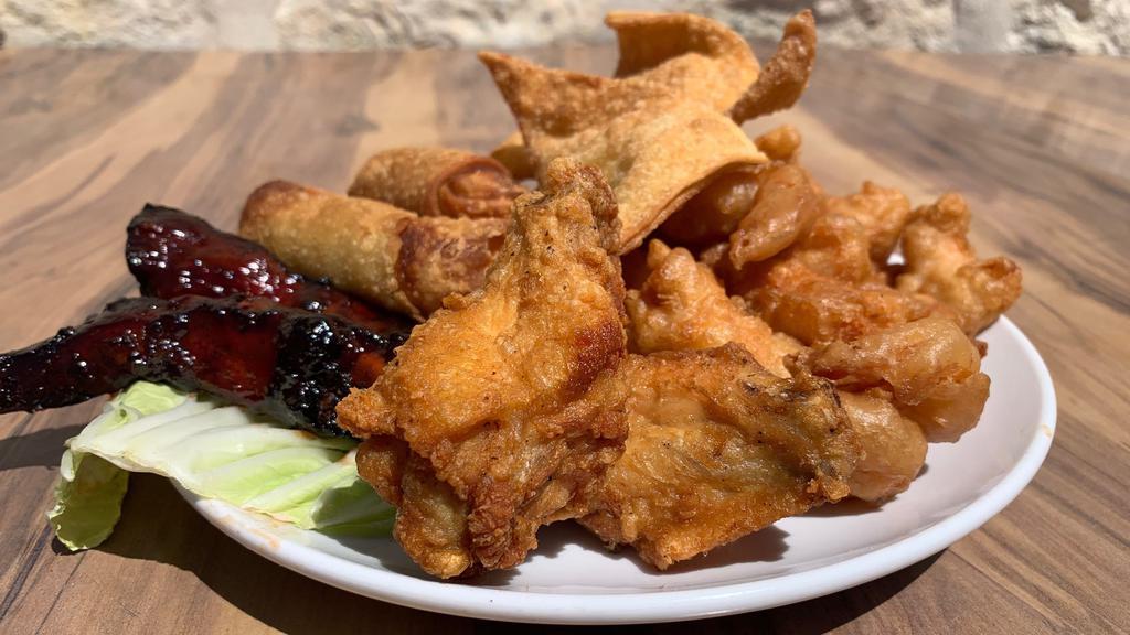 Panda Sampler · Served with pork egg rolls, cheese rangoons, pork BBQ spare ribs, fried shrimp, sweet and sour chicken and pork.