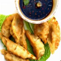 8 Pork Dumplings Fried · Our house seasoned pork dumplings deep fried and served with a cup of spicy garlic sauce.