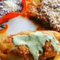 Pescado Xanath · Fresh white fish fillet stuffed with shrimp and crab. Served with two cheese enchiladas, bla...