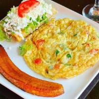 Torta Tolteca · A flat omelet with potatoes, onion, tomato, and jalapeño. Served with a side of plantains an...