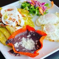 Chicken Chilaquiles · Two eggs any style, pork tamale, gordita, chiliquiles, black beans and rice.