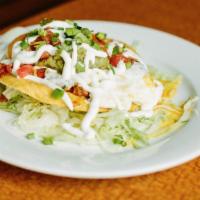 Huevos Rancheros · 2 eggs (any style) piled high on crispy and soft corn tortillas layered with refried beans, ...