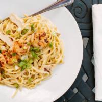 Land & Sea Pasta · Seasoned grilled chicken and shrimp tossed in creamy Parmesan alfredo sauce with a touch of ...