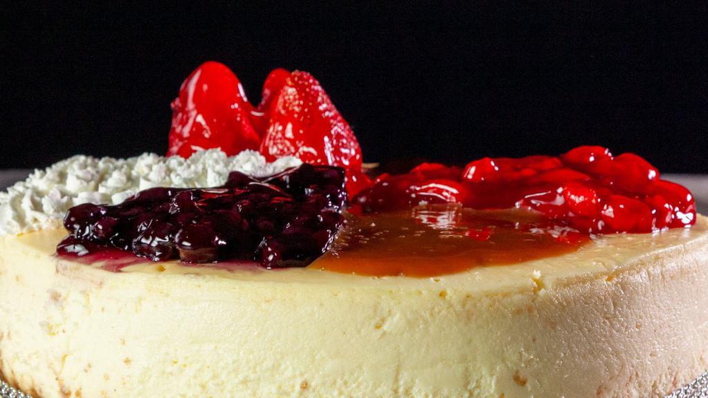 Cheesecake · Rich and creamy New York style cheesecake. Choose your topping - strawberry, blueberry, cherry or caramel.