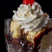 Outrageous Brownie Sundae · A warm decadent fudge brownie, French vanilla ice cream, and hot fudge, topped with real whi...