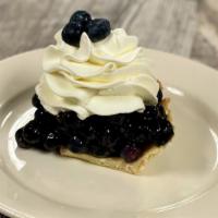 Blueberry Cream Pie · Fresh blueberries tossed in our blueberry glaze and placed in a cookie-style pie crust. Topp...