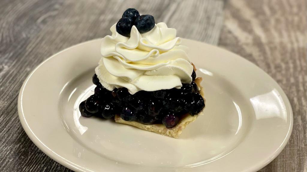 Blueberry Cream Pie · Fresh blueberries tossed in our blueberry glaze and placed in a cookie-style pie crust. Topped with fresh whipped cream.