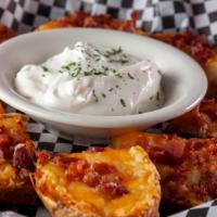 Potato Skins · Fresh cut potatoes loaded with cheese, crisp bacon and topped with our secret seasoning. Ser...