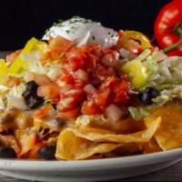 Ultimate Nachos · Crispy tortilla chips with melted cheddar and Monterey jack cheese, topped with our homemade...