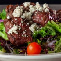 Steak Tip Salad · Juicy grilled steak tips served over fresh mixed greens with red onion, cucumbers, crumbled ...