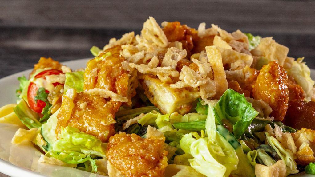 Crazy Chicken Salad · Our fresh mixed greens with cucumbers, grape tomatoes, sliced black olives, golden raisins, candied walnuts, fried wonton strips, cold penne pasta, and fried chicken. Served with your choice of dressing.