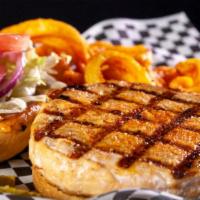 Salmon Burger · A half-pound salmon patty seasoned with our secret seasoning and topped with red onions, tom...