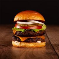 The Double Cheeseburger · Two beef patties, lettuce, tomato, onion, pickles, mayo, and melted cheddar cheese on a chal...