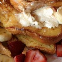 Strawberry Banana French Toast · Classic French toast topped with bananas and strawberries. Served with butter and syrup.