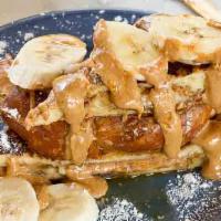 Peanut Butter & Banana French Toast · Classic French toast topped with peanut butter and banana. Served with syrup and butter.