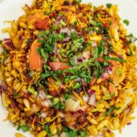 Bhel Puri · Popped rice, tamarind sauce, and mint sauce, potatoes, onion spices.
