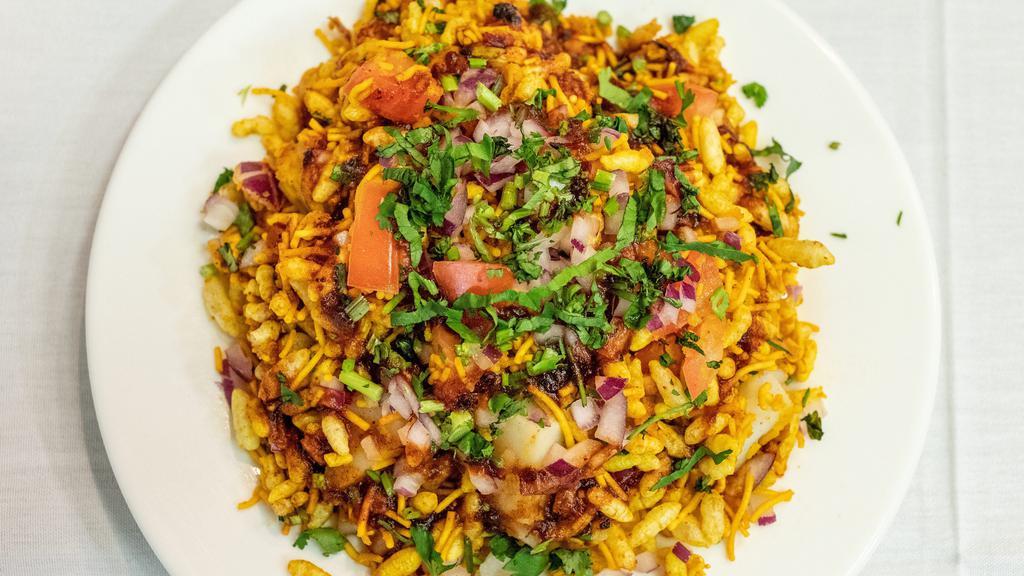 Bhel Puri · Popped rice, tamarind sauce, and mint sauce, potatoes, onion spices.