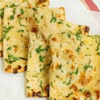 Garlic Naan · A popular, aromatic naan topped with fresh chopped garlic and spices.