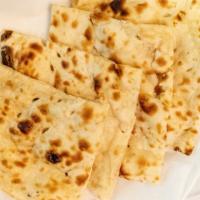 Naan · Teardrop shaped traditional Punjabi white bread baked in the Tandoor.