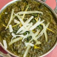 Saag Paneer · Fresh home-made Indian cheese cubes gently cooked with garden spinach and mild spices.