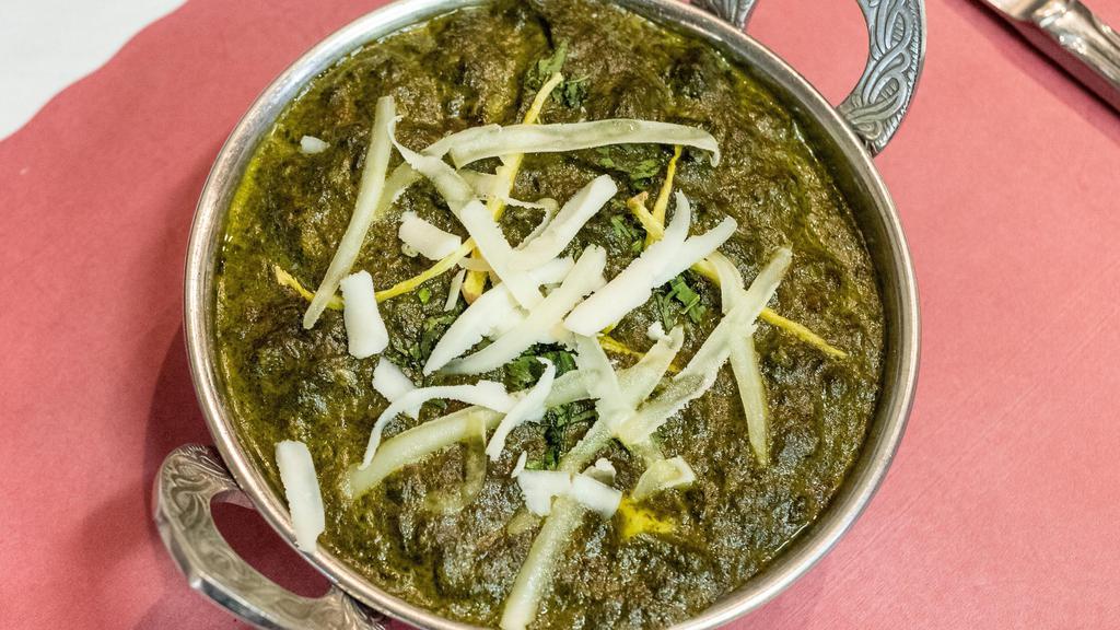 Saag Paneer · Fresh home-made Indian cheese cubes gently cooked with garden spinach and mild spices.