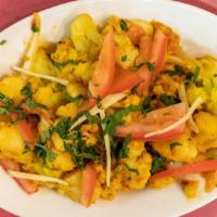 Aloo Gobhi Palak · Fresh cauliflower, potatoes, and spinach, cooked with tomatoes, ginger, and seasoning.