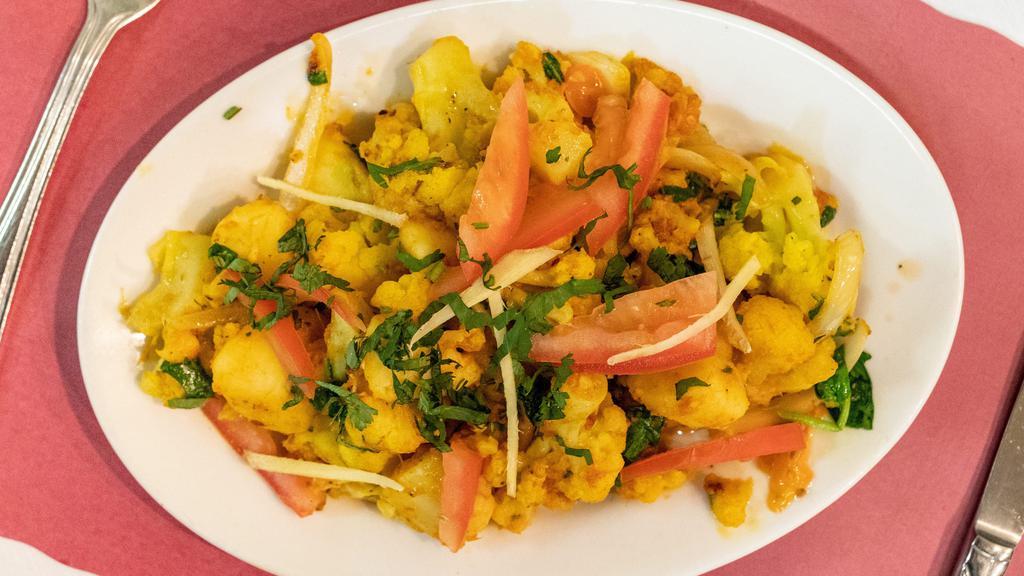 Aloo Gobhi Palak · Fresh cauliflower, potatoes, and spinach, cooked with tomatoes, ginger, and seasoning.