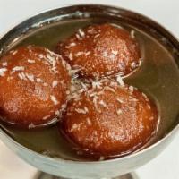 Gulab Jamun · A light pastry ball made with milk and honey in a thick syrup.