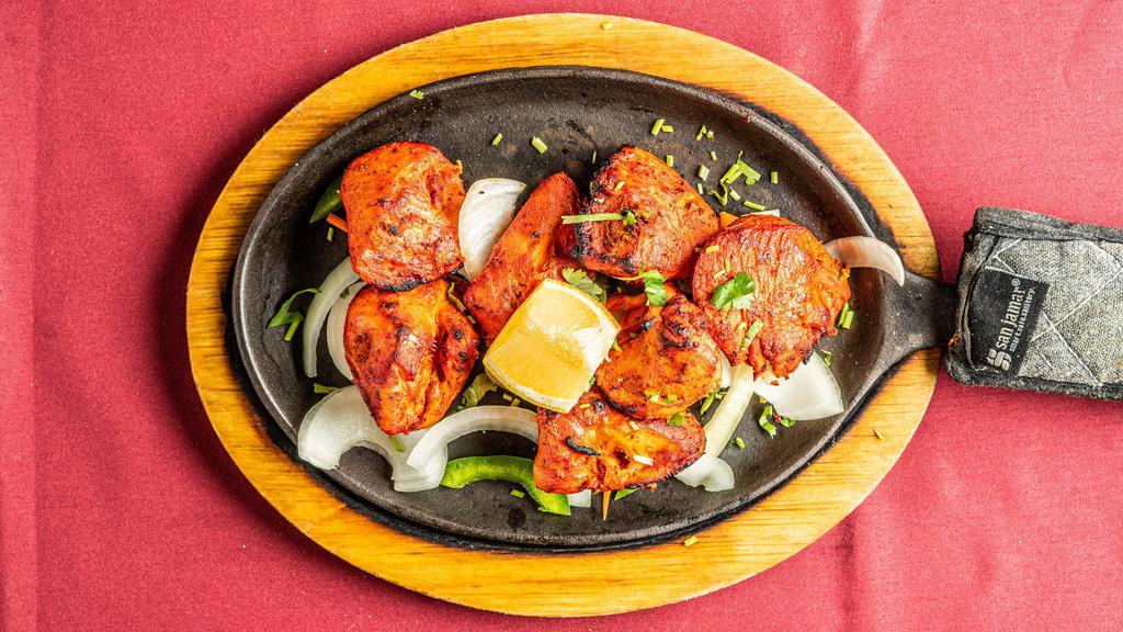 Chicken Tikka · Boneless chicken breasts marinated in yogurt and spices and baked on skewers.