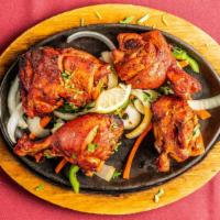 Chicken Tandoori · Tender chicken marinated in yogurt and spices and baked on skewers.