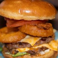 American Burger · Two Smashed Beef Patties served in a large Brioche Bun with Lettuce, tomato, onion rings, gh...