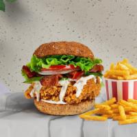 Strippin' Cado Chicken Sandwich · Crispy fried chicken, sliced avocado, crispy bacon, lettuce, tomatoes, and house mayo. Serve...