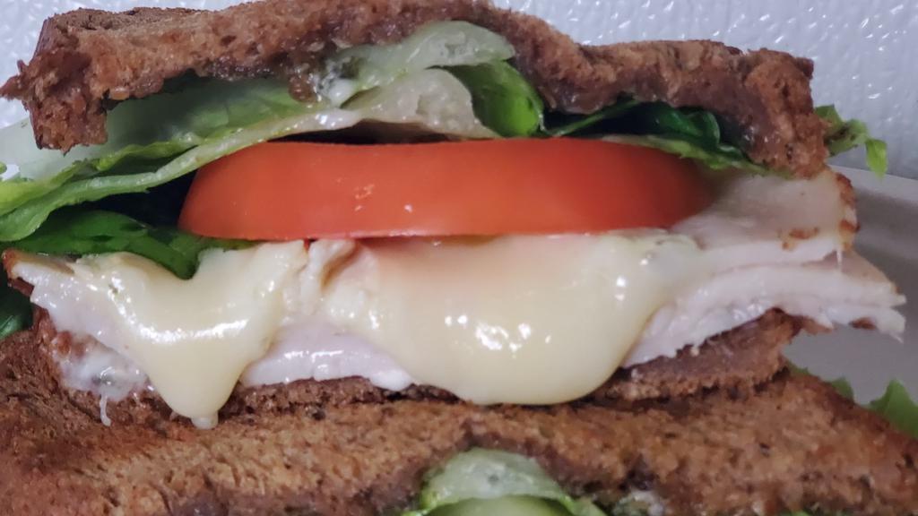 Turkey Brie · Turkey, brie cheese, lettuce, tomatoes, and herb mayo.