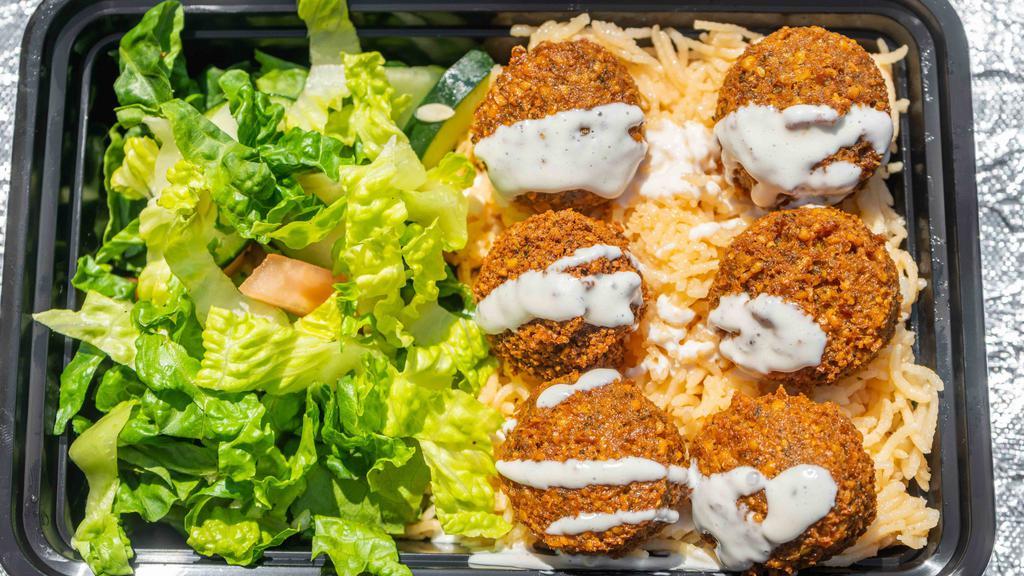 Falafel Plate Over Rice · Vegetarian. Halal. Healthy. Fried veggie balls made fresh to order over spiced basmati rice and side salad. Served with signature red and white sauces.