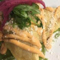 Empanadas De Queso Con Rajas · Spicy. Two fried turnovers stuffed with Oaxaca cheese and poblano peppers strips on a bed of...