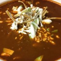 Esquite Poblano Soup · Chicken-based, Puebla-style corn soup with one chicken leg, garnished with chili powder, cri...